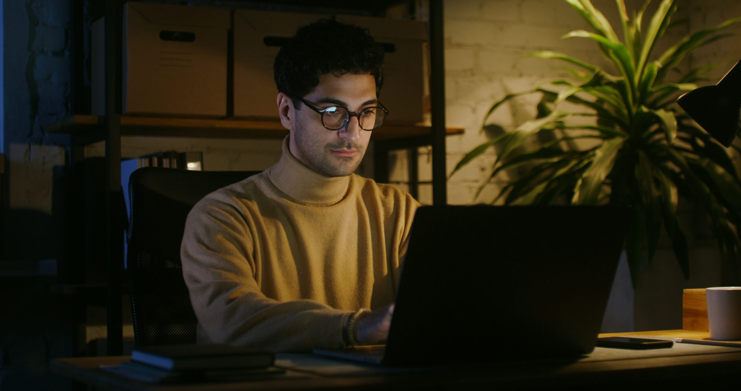 young man at computer wearing glasses